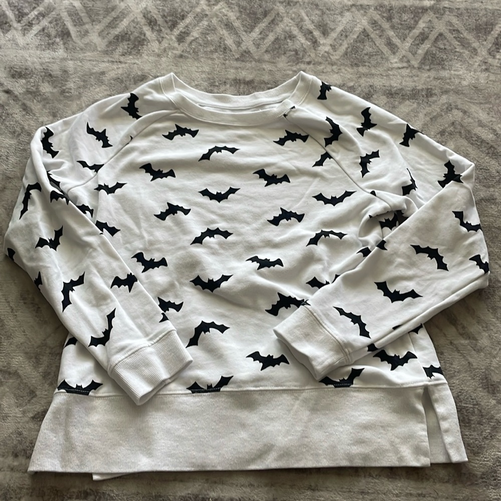 Small white long sleeve shirt/pullover with black bat prints